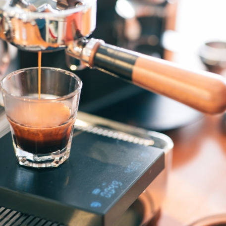 espresso-is-being-filling-glass-from-portafilter-espresso-machine-precision-balance-equipment-is-used